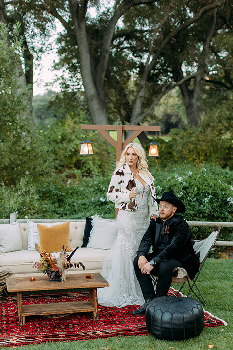  a moody western wedding with burgundy and orange colors - couple in western wear 