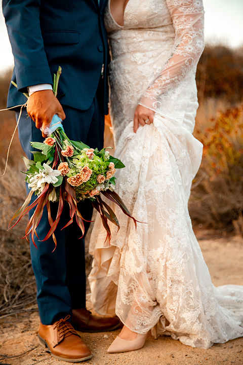  newport wedding in the cliffs with the bride in a lace gown and the groom in a navy blue suit – couple close up 