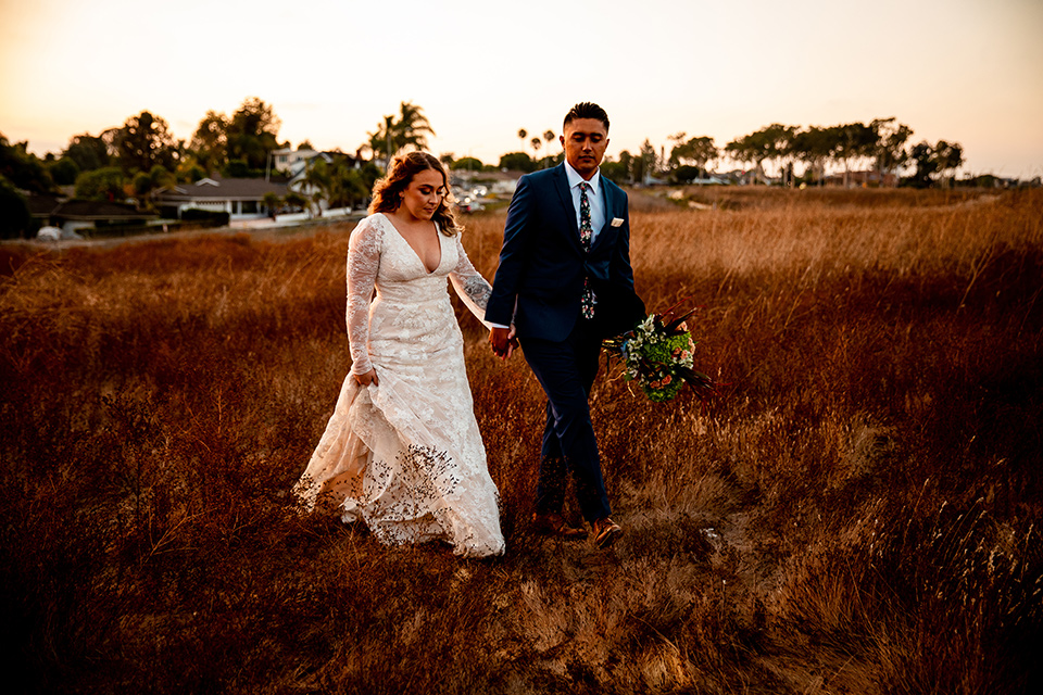  newport wedding in the cliffs with the bride in a lace gown and the groom in a navy blue suit – sunset 