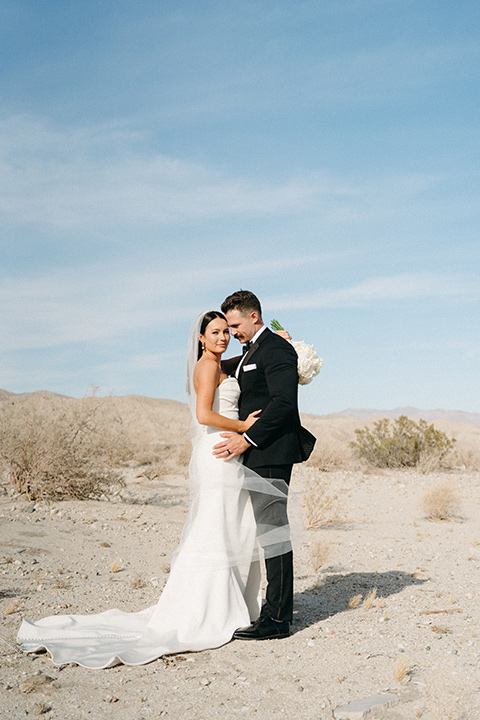  a trendy black and white wedding with modern details - couple on the sand 