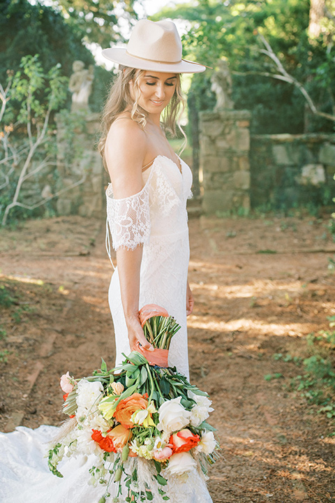  blush and burgundy wedding in the woods with the bride in a boho lace gown, the groom in a burgundy shawl tuxedo, and the bridesmaids in a dusty blush velvet gown – bride
