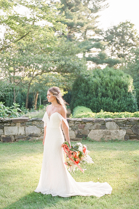  blush and burgundy wedding in the woods with the bride in a boho lace gown, the groom in a burgundy shawl tuxedo, and the bridesmaids in a dusty blush velvet gown – bride