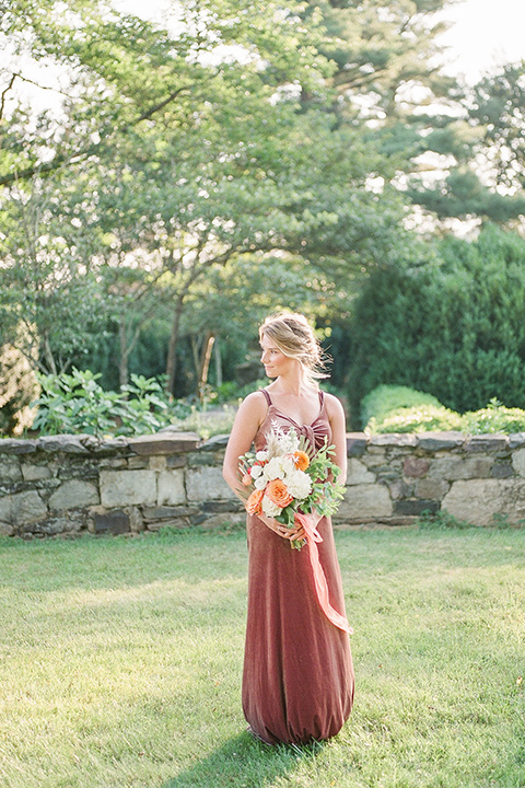  blush and burgundy wedding in the woods with the bride in a boho lace gown, the groom in a burgundy shawl tuxedo, and the bridesmaids in a dusty blush velvet gown – bridesmaid