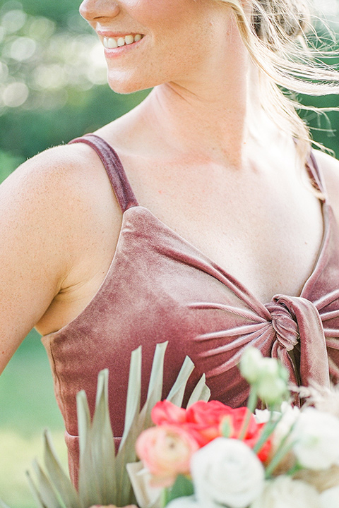  blush and burgundy wedding in the woods with the bride in a boho lace gown, the groom in a burgundy shawl tuxedo, and the bridesmaids in a dusty blush velvet gown – bridesmaid