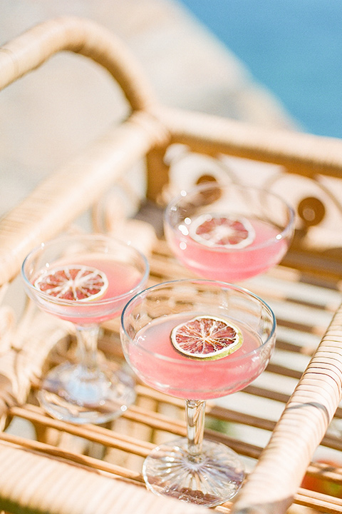  blush and burgundy wedding in the woods with the bride in a boho lace gown, the groom in a burgundy shawl tuxedo, and the bridesmaids in a dusty blush velvet gown – cocktails