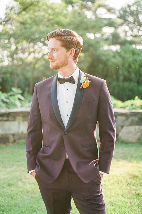  blush and burgundy wedding in the woods with the bride in a boho lace gown, the groom in a burgundy shawl tuxedo, and the bridesmaids in a dusty blush velvet gown – groom