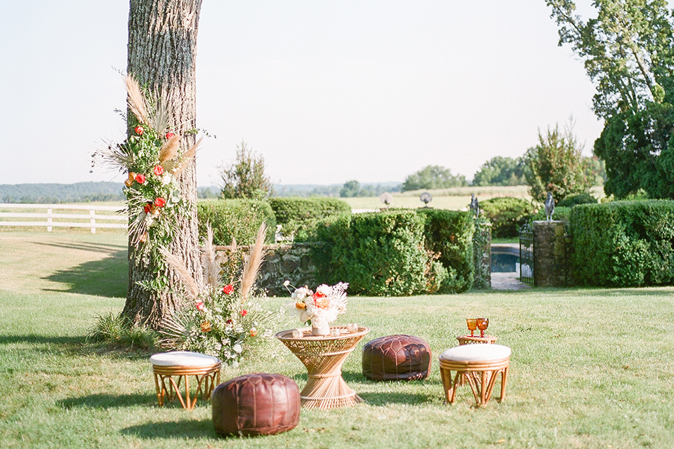  blush and burgundy wedding in the woods with the bride in a boho lace gown, the groom in a burgundy shawl tuxedo, and the bridesmaids in a dusty blush velvet gown – reception decor