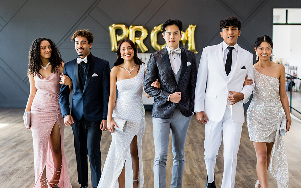  group of friends having fun at prom with the girls wearing dresses from Windsor and the guys wearing suits and tuxedos from Friar Tux