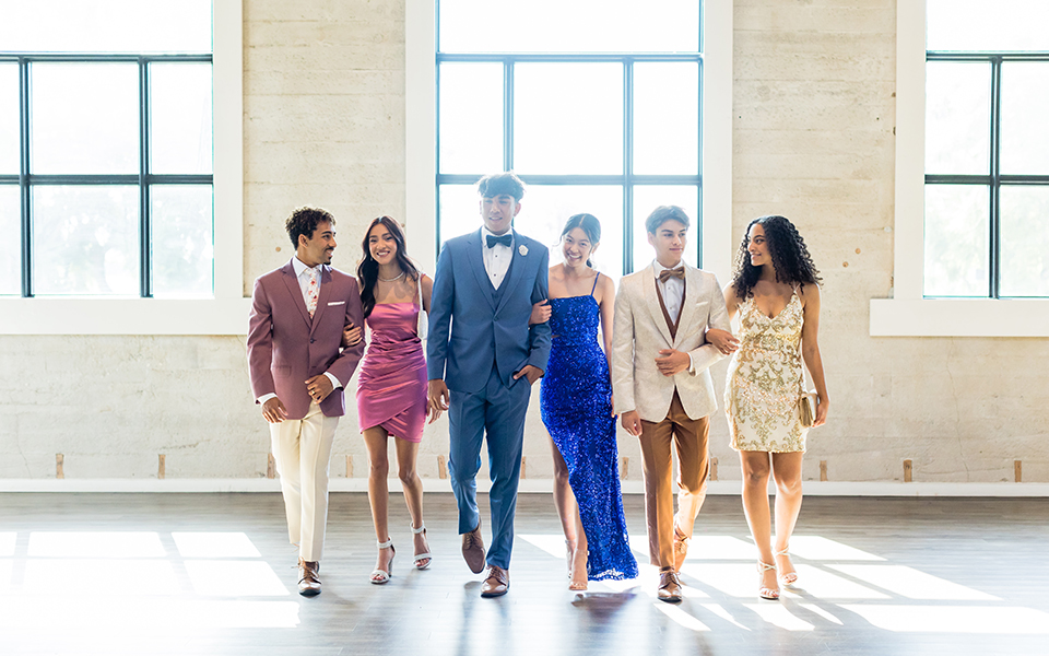  group of friends having fun at prom with the girls wearing dresses from Windsor and the guys wearing suits and tuxedos from Friar Tux