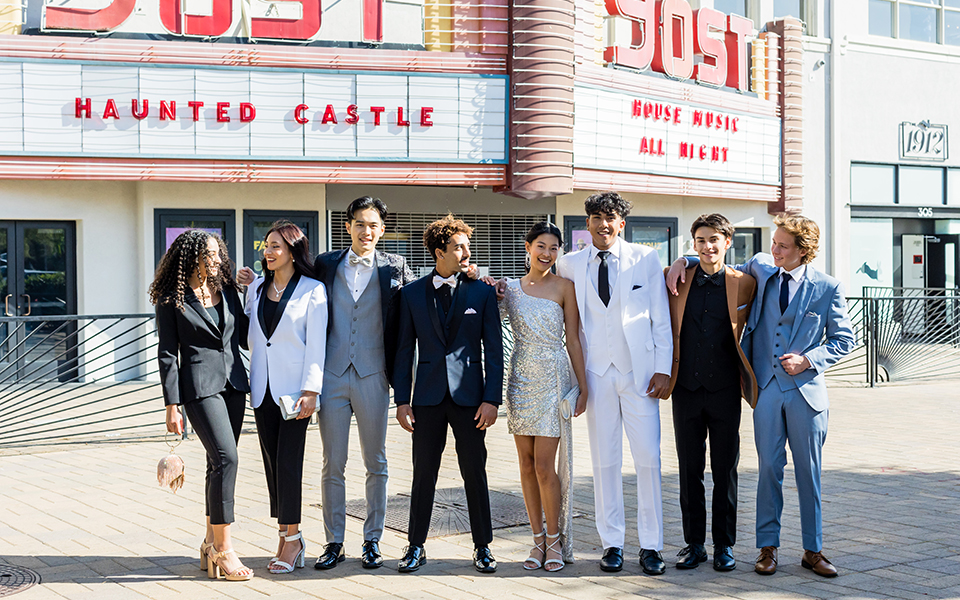  group of friends having fun at prom with the girls wearing dresses from Windsor and the guys wearing suits and tuxedos from Friar Tux