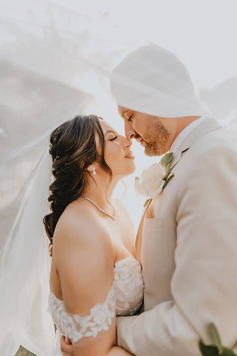  romantic neutral wedding with Spanish flare – couple kissing under veil