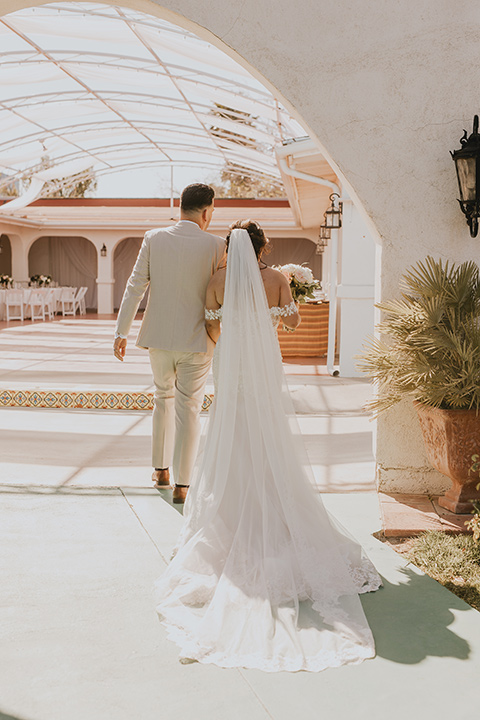  romantic neutral wedding with Spanish flare – couple walking 