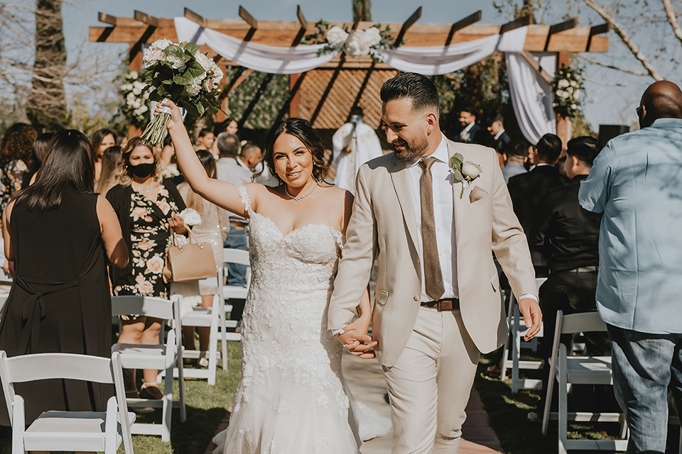  romantic neutral wedding with Spanish flare – couple celebrating after ceremony