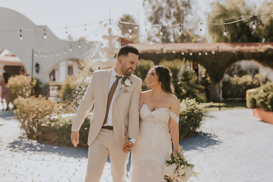  romantic neutral wedding with Spanish flare – couple walking