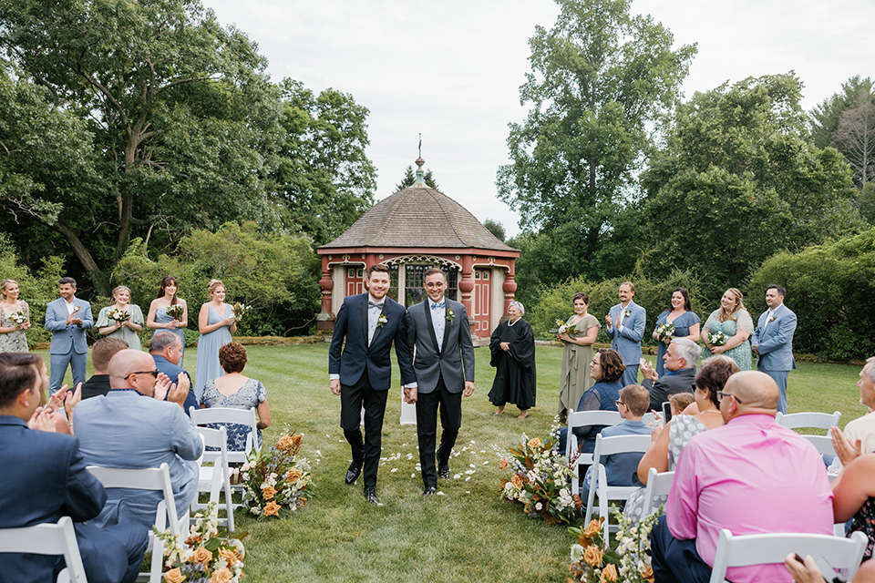  english garden wedding with blue and green touches – grooms walking down the aisle
