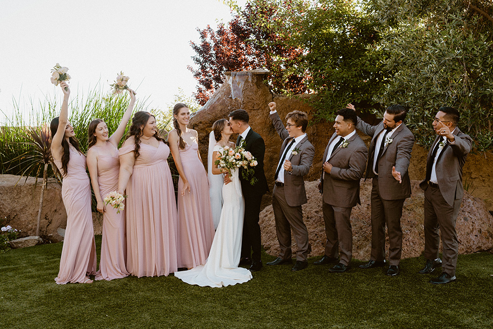  blush and beige wedding with a chic modern twist – the bride in a cap sleeved fitted gown and the groom in a black suit – bridal party