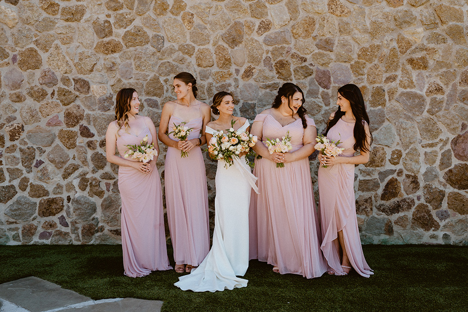  blush and beige wedding with a chic modern twist – the bride in a cap sleeved fitted gown and the groom in a black suit – bridesmaids