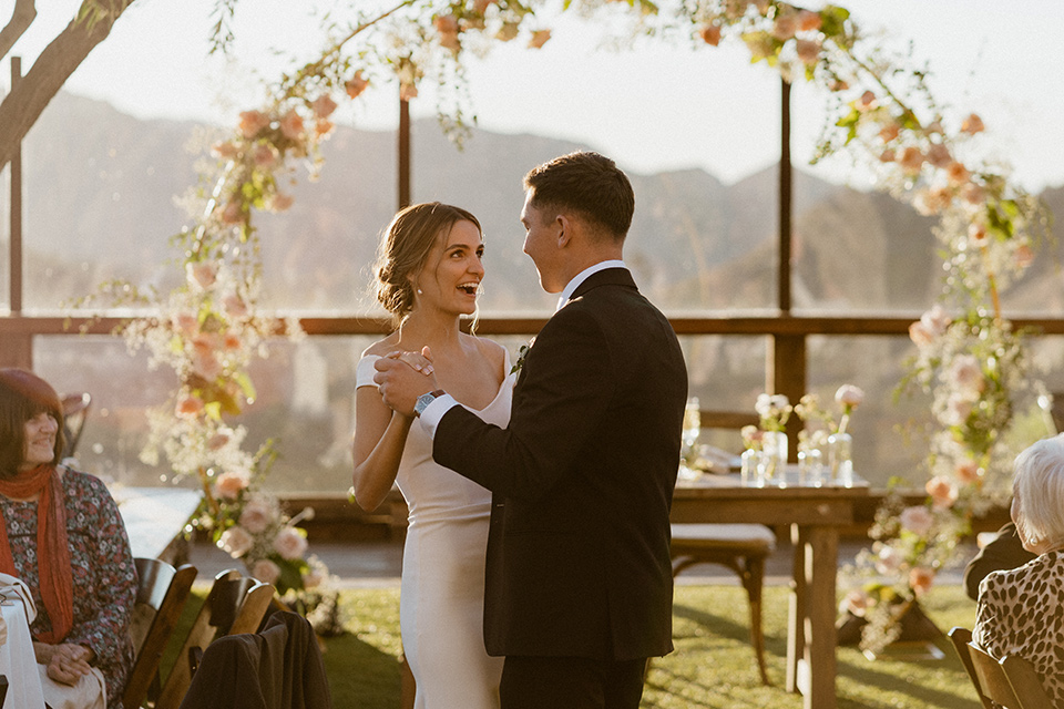  blush and beige wedding with a chic modern twist – the bride in a cap sleeved fitted gown and the groom in a black suit – vows