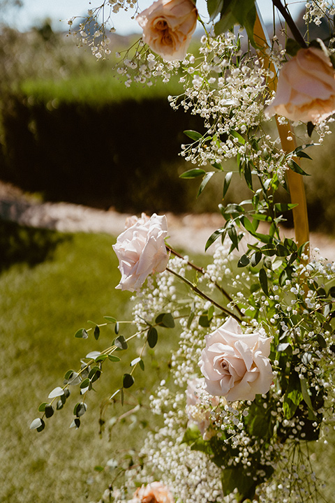  blush and beige wedding with a chic modern twist – the bride in a cap sleeved fitted gown and the groom in a black suit – flowers