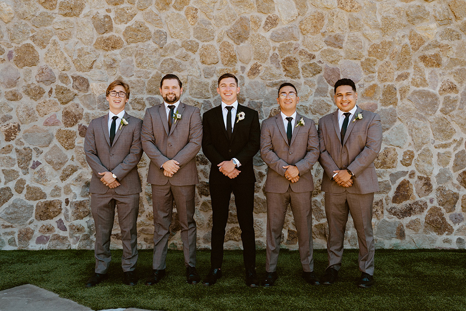  blush and beige wedding with a chic modern twist – the bride in a cap sleeved fitted gown and the groom in a black suit – groomsmen