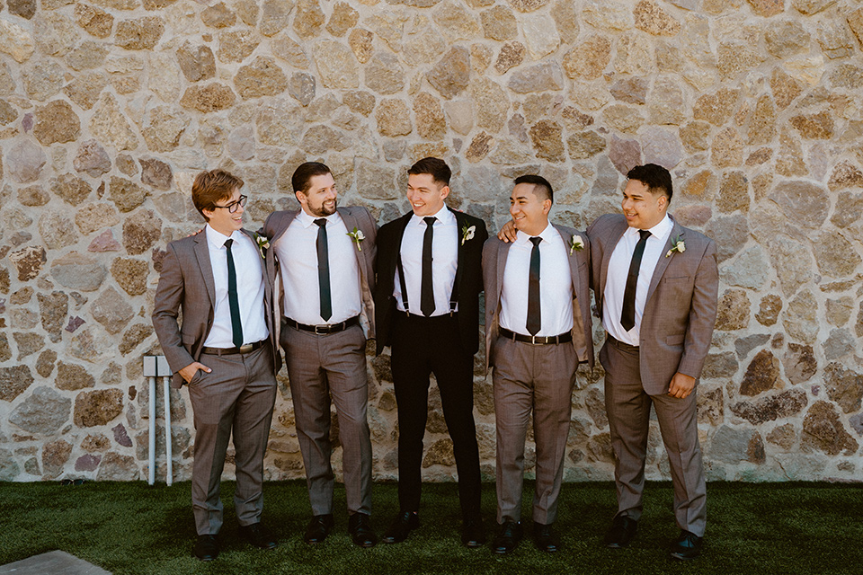  blush and beige wedding with a chic modern twist – the bride in a cap sleeved fitted gown and the groom in a black suit – groomsmen