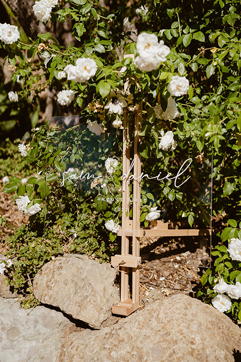  blush and beige wedding with a chic modern twist – the bride in a cap sleeved fitted gown and the groom in a black suit – signage