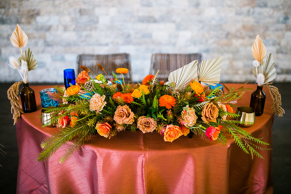  jewel toned wedding with the bride in a ballgown and the groom in a blue velvet tuxedo – sweetheart table