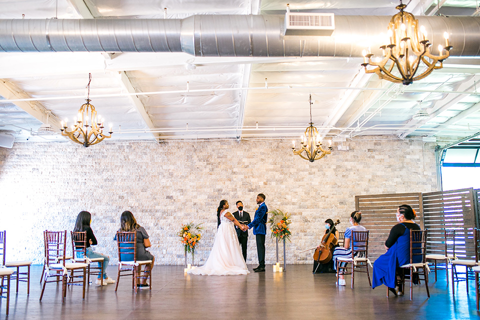  jewel toned wedding with the bride in a ballgown and the groom in a blue velvet tuxedo – ceremony