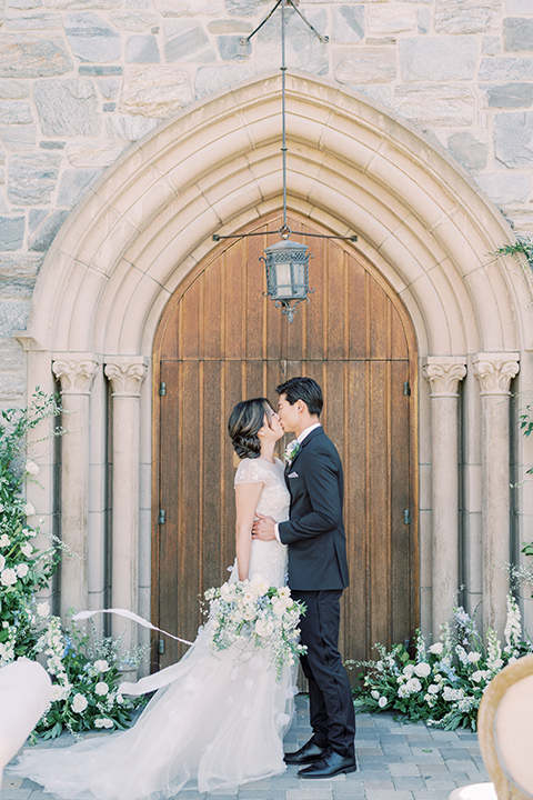  old world wedding style with the bride is a Bridgerton-style gown and the groom in an asphalt suit - ceremony 