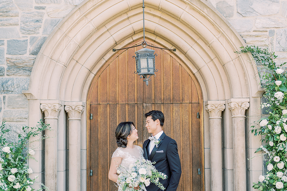  old world wedding style with the bride is a Bridgerton-style gown and the groom in an asphalt suit – ceremony 