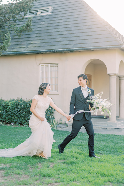  old world wedding style with the bride is a Bridgerton-style gown and the groom in an asphalt suit - reception tables and sweetheart table 