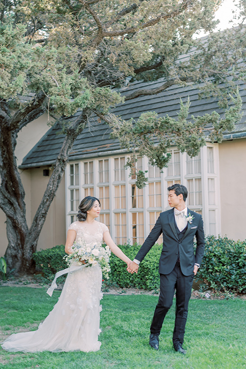  old world wedding style with the bride is a Bridgerton-style gown and the groom in an asphalt suit - couple running 