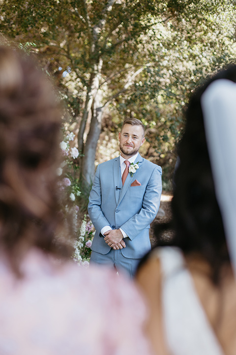  a classic blush and blue wedding design in a garden venue - bride walking down the aisle 
