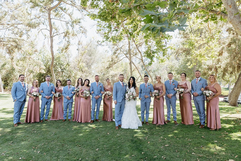  a classic blush and blue wedding design in a garden venue - wedding party 