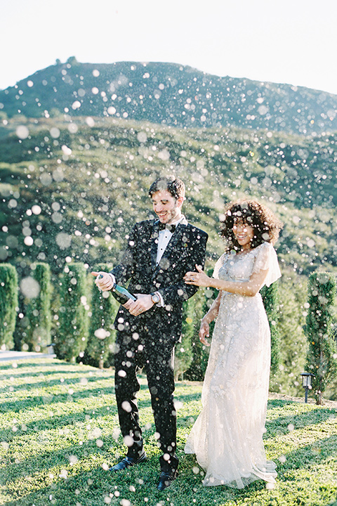  classic black tie wedding at the stone mountain estate – couple with champagne 