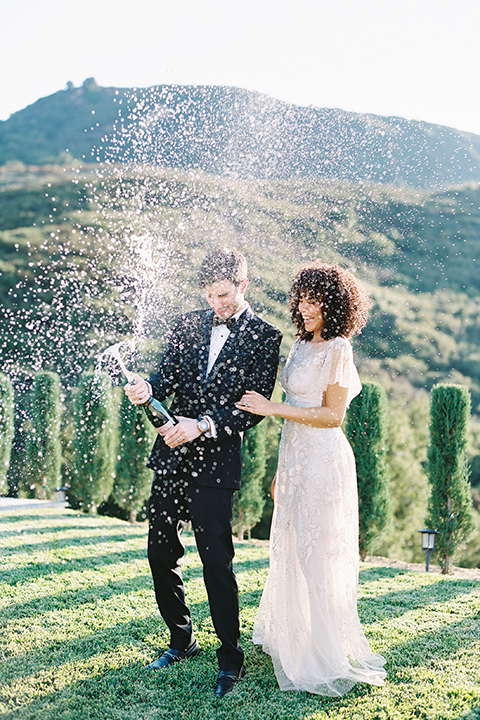  classic black tie wedding at the stone mountain estate – couple with champagne 