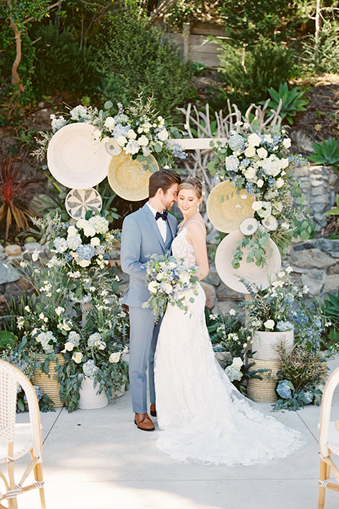  blue beachy wedding with blue and pink décor and the groom in a light blue suit – couple at ceremony 