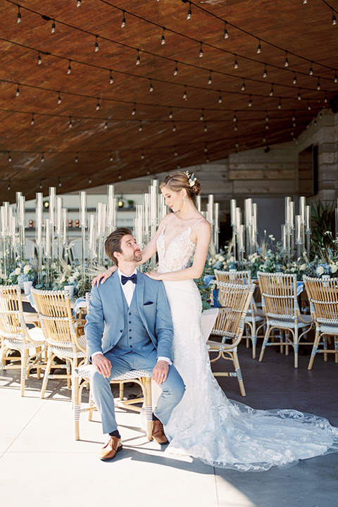  blue beachy wedding with blue and pink décor and the groom in a light blue suit – couple at tables 