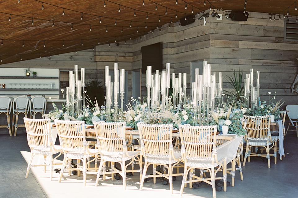  blue beachy wedding with blue and pink décor and the groom in a light blue suit – table