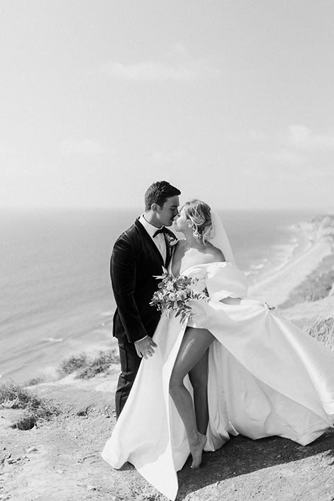  elopement on the cliffs with the bride in a ball gown with poof sleeves and the groom in a green velvet tuxedo 