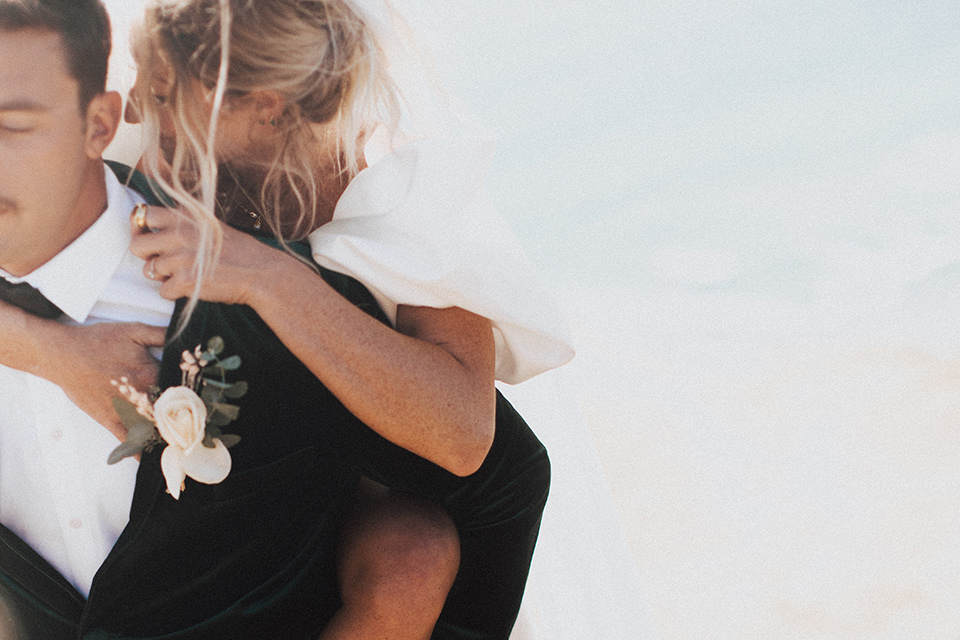  elopement on the cliffs with the bride in a ball gown with poof sleeves and the groom in a green velvet tuxedo 