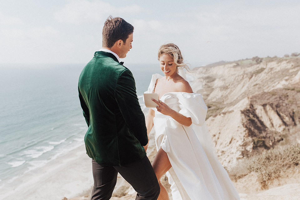  elopement on the cliffs with the bride in a ball gown with poof sleeves and the groom in a green velvet tuxedo 