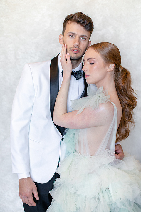  fun wedding at the Westgate hotel and the bride in a blue tulle gown and the groom in a white and black tuxedo - couple outside walking 