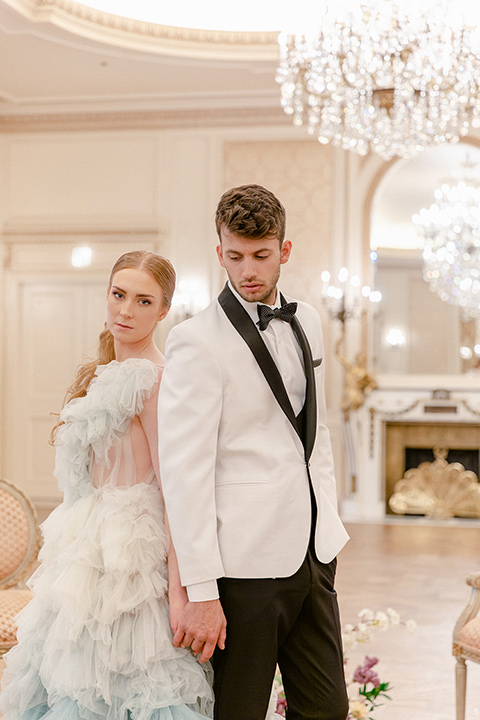  fun wedding at the Westgate hotel and the bride in a blue tulle gown and the groom in a white and black tuxedo - couple inside ceremony 