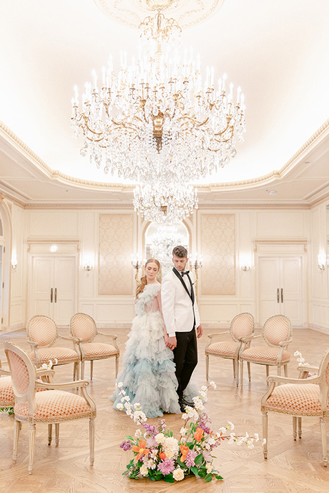  fun wedding at the Westgate hotel and the bride in a blue tulle gown and the groom in a white and black tuxedo - couple inside ceremony 