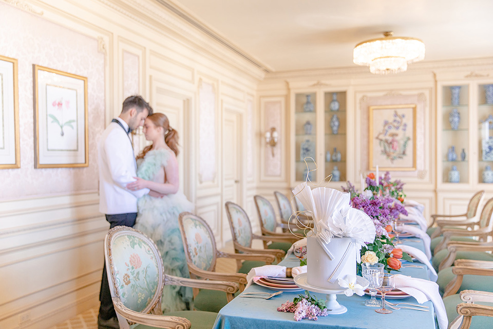  fun wedding at the Westgate hotel and the bride in a blue tulle gown and the groom in a white and black tuxedo – couple by the table 