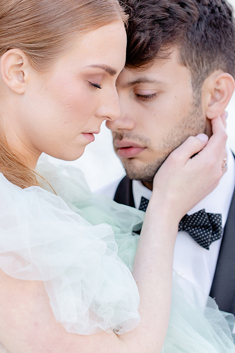  fun wedding at the Westgate hotel and the bride in a blue tulle gown and the groom in a white and black tuxedo - couple outside by fountain 