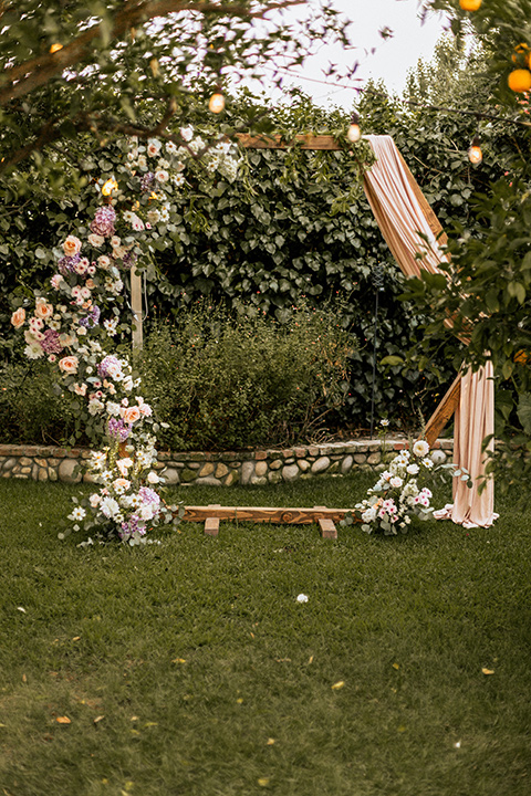  whimsical fairytale wedding with the groom in a gold velvet tuxedo – ceremony altar