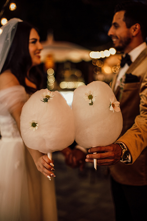  whimsical fairytale wedding with the groom in a gold velvet tuxedo – couple with cotton candy