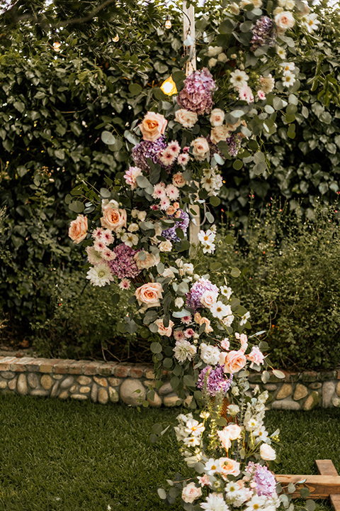  whimsical fairytale wedding with the groom in a gold velvet tuxedo – ceremony altar 